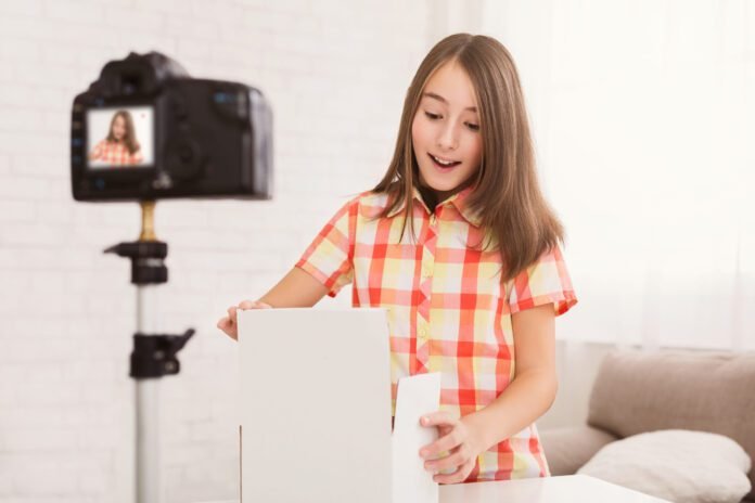 Pre-teen girl opening box and gasping in surprise
