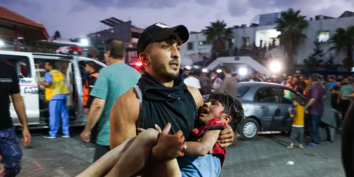 man-carries-a-child-wounded-by-israeli-airstrikes
