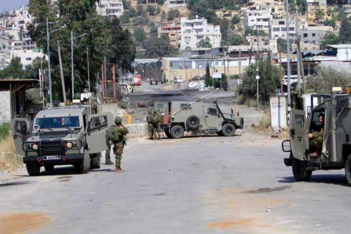 Israeli soldiers take positions during a demonstration
